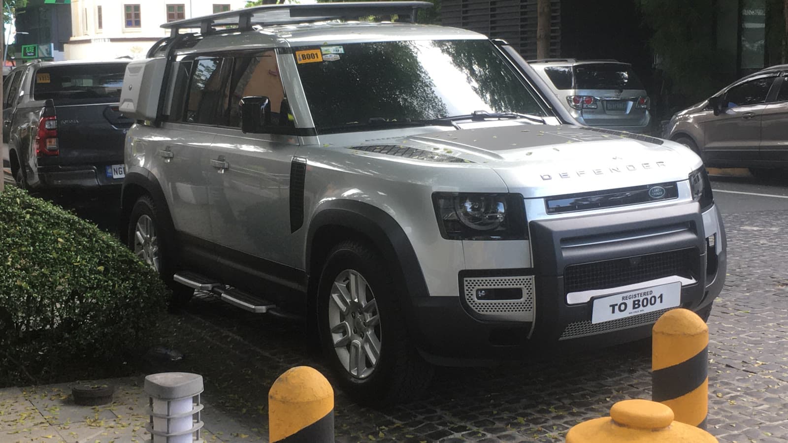Silver 2022 Land Rover Defender 110 parked outdoors, seen from the front left three-quarter view