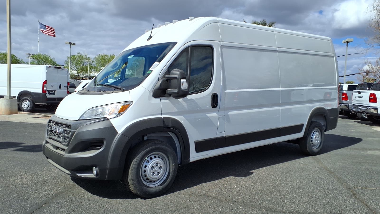 White 2025 Ram ProMaster 2500 high-roof cargo van parked on a dealer lot, seen from the front left